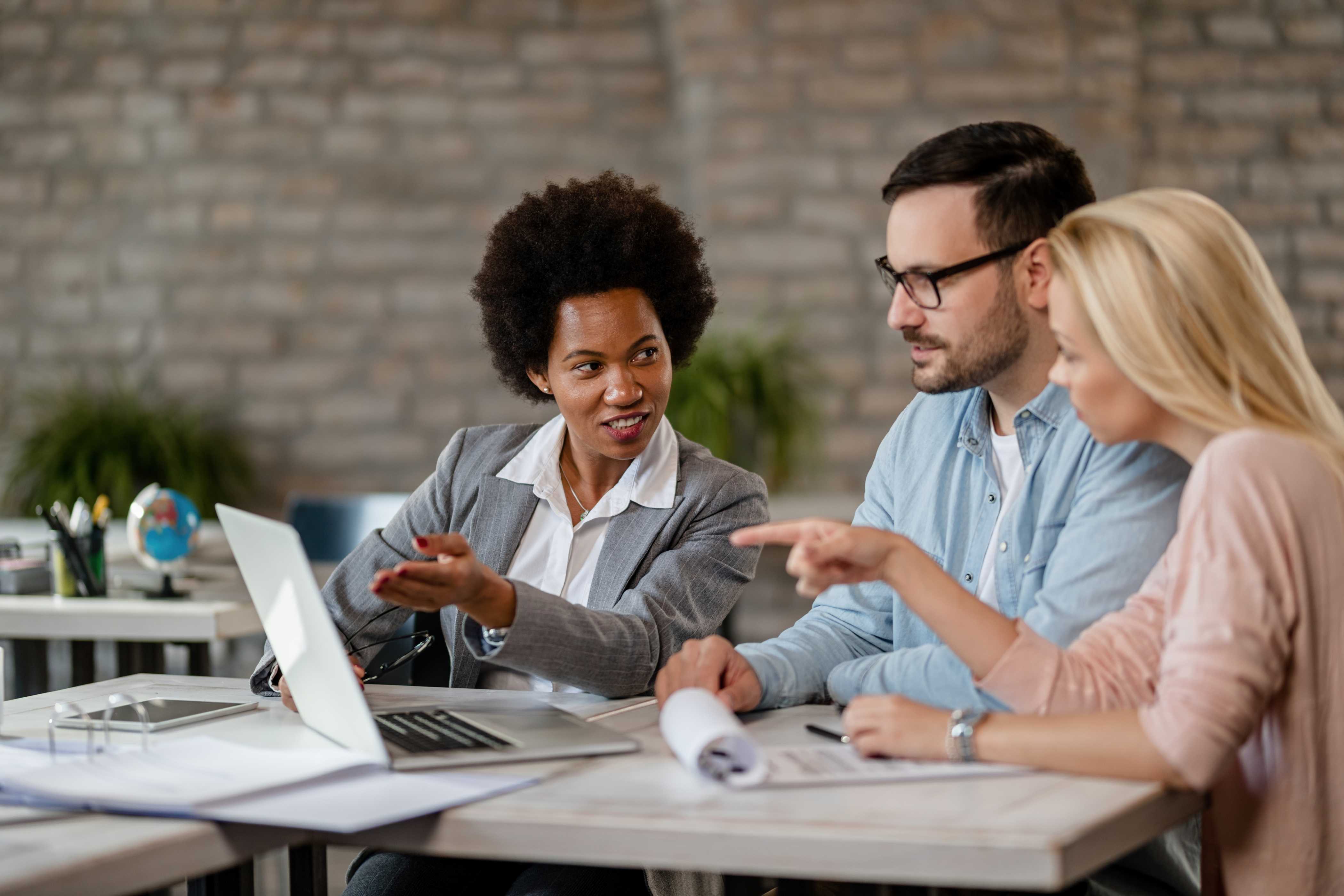 black-female-insurance-agent-using-computer-with-couple-consultations-office (1)